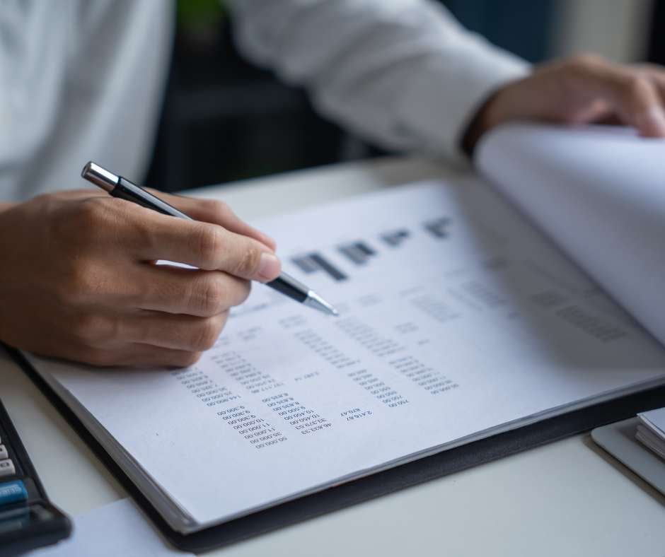 US business professional reviewing international hiring documents on a laptop while exploring Employer of Record (EOR) options in South Africa.