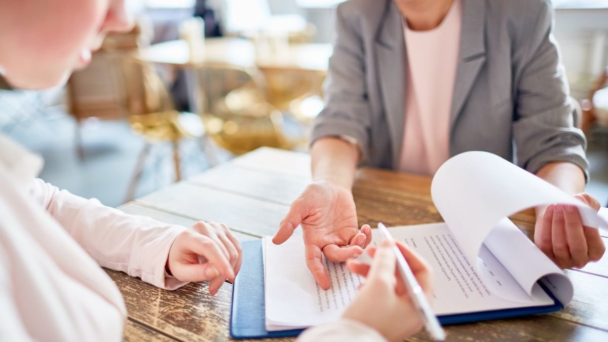 Legal employer in South Africa. Detailed close-up of business professionals reviewing a South African employment contract and compliance checklist, representing the detailed local legal support offered by Employer of Record South Africa.